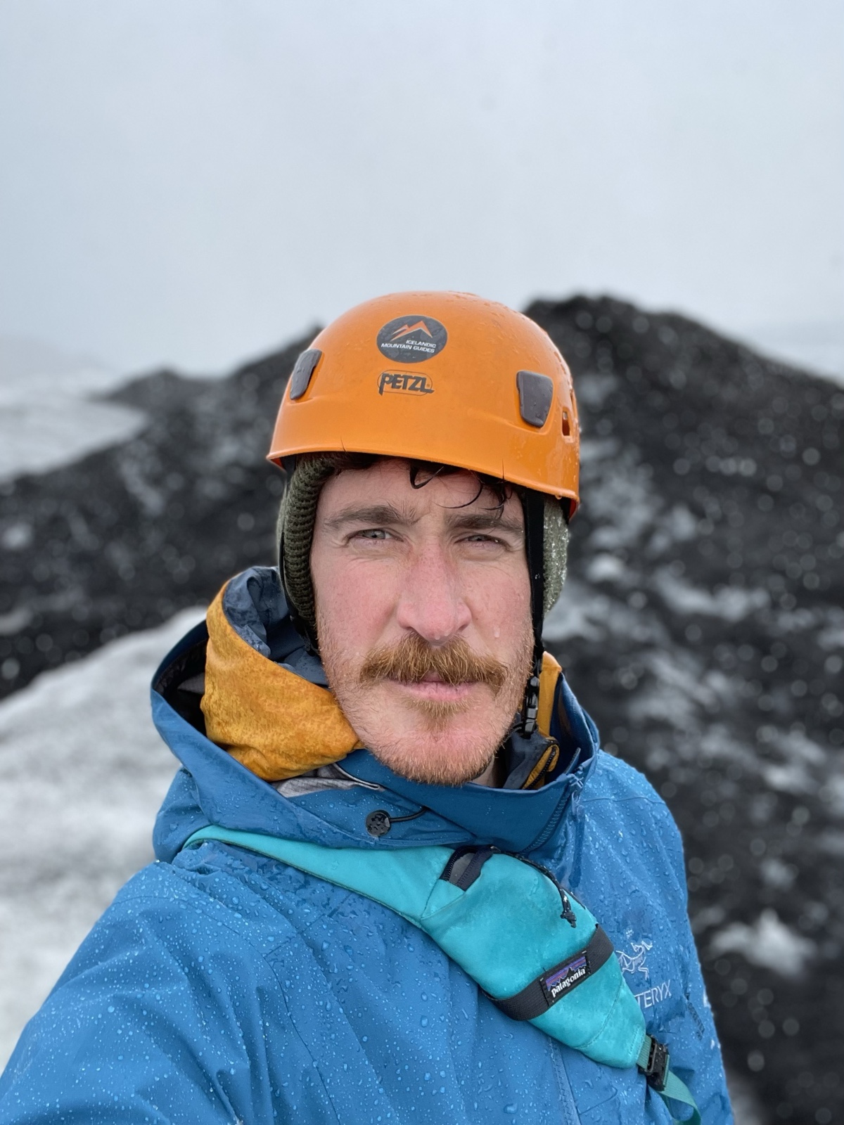On a glacier in Iceland, orange climbing helmet