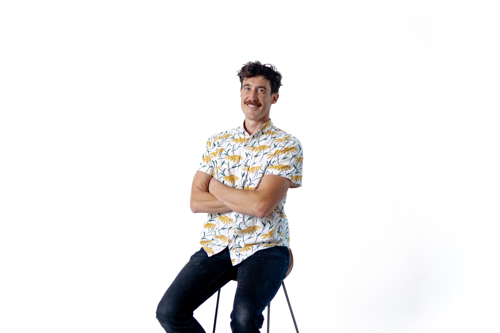 Alec Jankowski, perched on a stool, plotting something